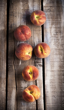 Peaches group overhead on old white rustic wooden table in studio