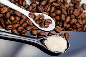 Coffee beans, brown sugar and small teaspoons