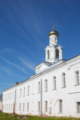 Fototapeta na wymiar St. George's monastery in sity Veliky Novgorod, orthodox Christian Church. The Orthodox religion of Russia. Monastery's oldest Church buildings in Russia in 1030 year. White Church with blue domes.