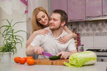 man and woman preparing a salad