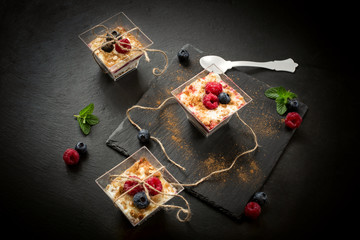 composition of glass dessert with yogurt cream and red fruits ov