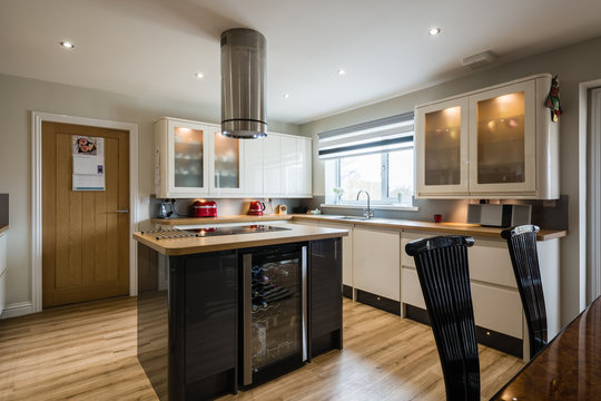 Modern Domestic Kitchen with high gloss units rounded corners and an island