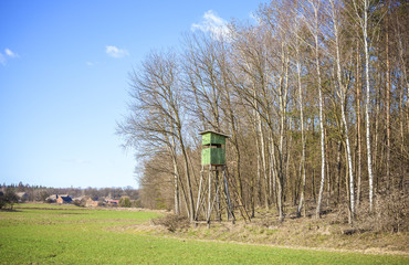 Hunting pulpit at the edge of a forest in spring.
