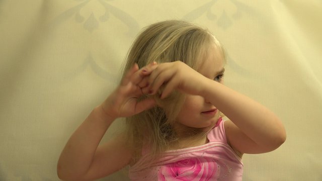 Girl Toddler Child Hair Dresses herself with a Hair Comb and Bru. 4K UltraHD video.
