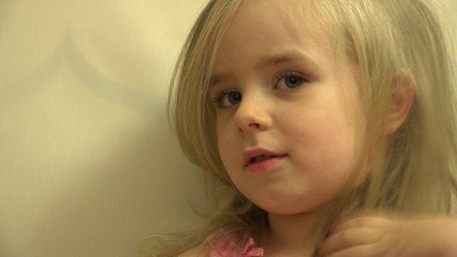 Girl Toddler Child Hair Dresses herself with a Hair Comb and Bru. 4K UltraHD video.