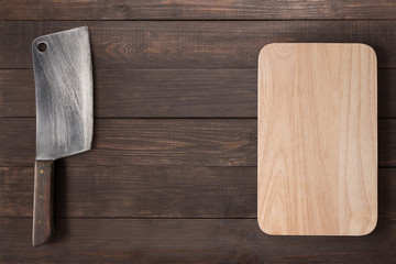 Cleaver and cutting board on the wooden background