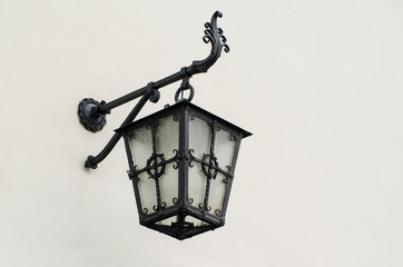 Iron lantern against the white wall