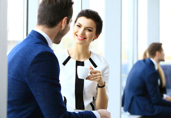 Young couple of professionals chatting during coffee break