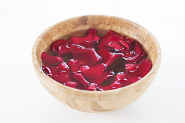 Red rose petals in bowl