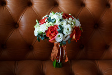 a Bridal bouquet lays on a dark background in the interior