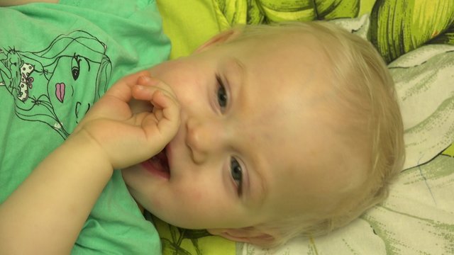 Father  Tickle his Baby in Bed. Closeup. 4K UltraHD video.