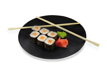 sushi roll with salmon on black plate