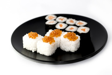 Roll with caviar on black plate