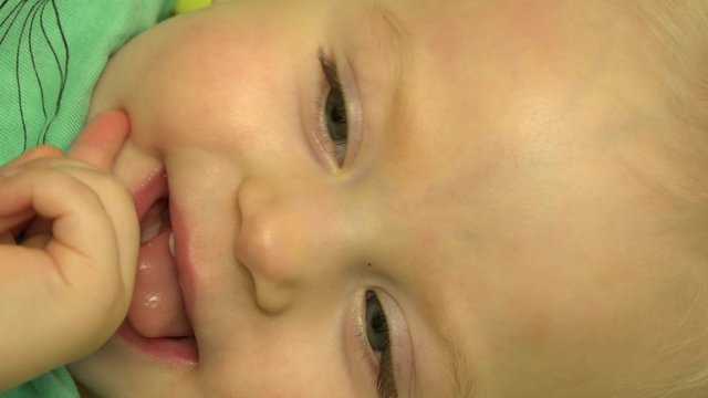 Father  Tickle his Baby in Bed. Closeup. 4K UltraHD video.