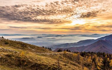 Naklejka na ściany i meble Sunset in the mountains. View of the valley