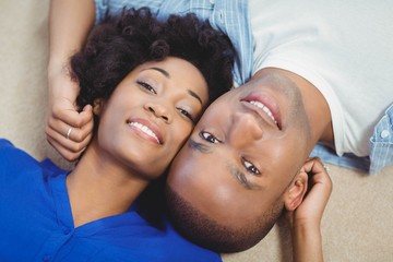 Portrait of smiling couple lying on the floor