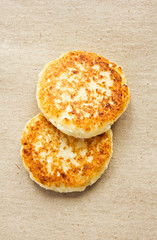 fritters of cottage cheese on kraft paper, top view