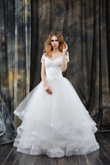 Fototapeta premium portrait of pretty bride in wedding dress