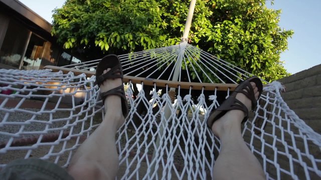 A Man Relaxing On A Hammock - POV