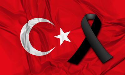 Black ribbon on flag of Turkey in memory of victims of terrorist attack