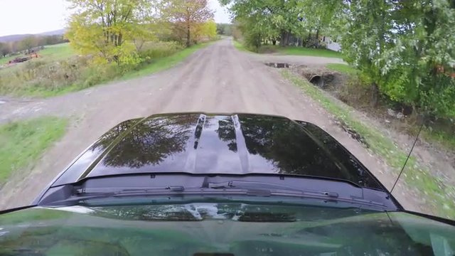 Point Of View From Truck Driving Down A Country Road