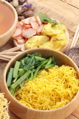 Egg noodles with pork and dumpling in soup.