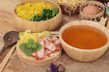 Egg noodles with pork and dumpling in soup.