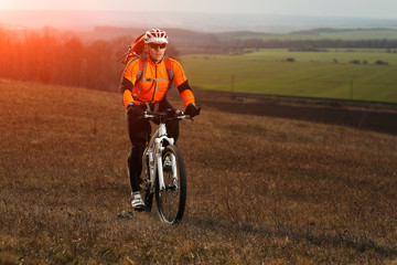 Man cyclist with backpack riding the bicycle