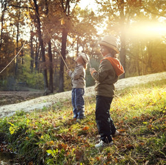 happy boys go fishing on the river