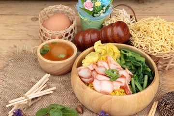Egg noodles with pork and dumpling in soup.