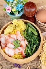 Egg noodles with pork and dumpling in soup.