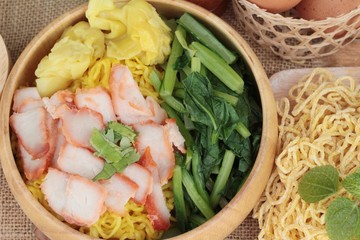Egg noodles with pork and dumpling in soup.