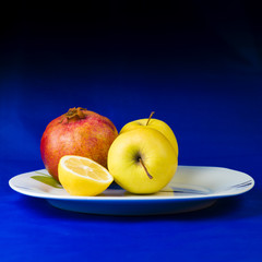 pomegranate apple lemon on a plate