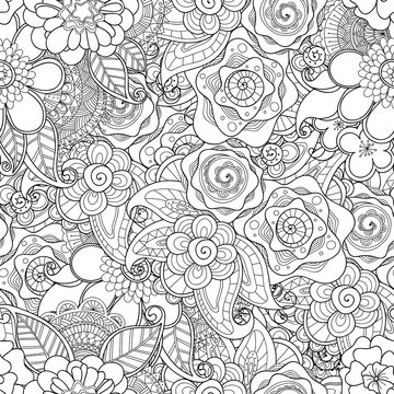 Doodle flowers seamless pattern. Zentangle style flowers and leaves background. Black and white hand drawn herbal pattern.