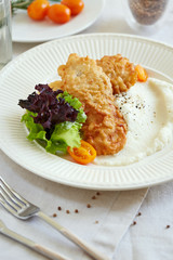a portion of fried fish with cauliflower puree