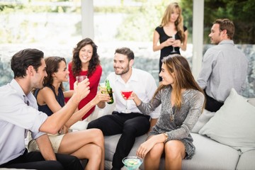 Group of friends talking and having drinks