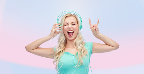 happy young woman or teenage girl with headphones