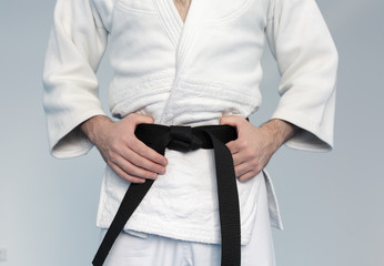 Martial arts Master with black belt in white kimono