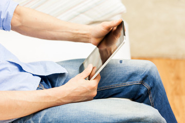close up of man working with tablet pc at home