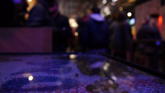 unfocused people walking in a nightclub