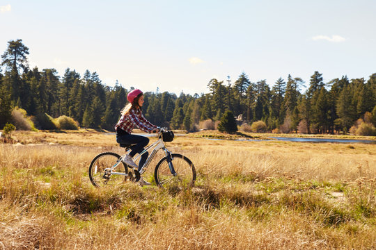 Girl cycling in the countryside, California, USA