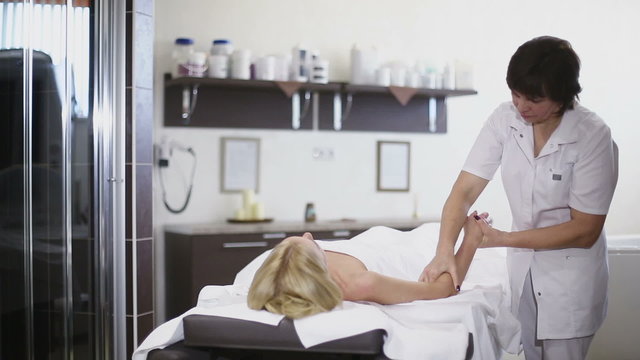 Woman having massage in spa. Slider camera movement