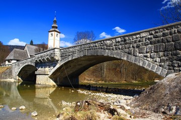Old stone bridge on river Sava Bohinjka in Slovenia