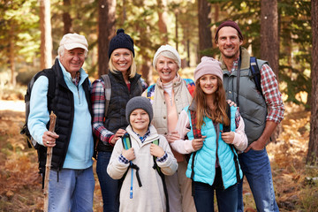 Multi generation family on hike in forest, group portrait
