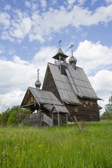 Fototapeta na wymiar the wooden Orthodox Russian Church in the background of cloudy sky