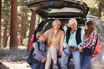 Grandparents and grandkids at the back of car before hiking