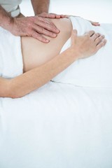 Obraz na płótnie Canvas Pregnant woman receiving a stomach massage 