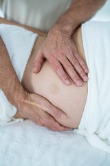 Fototapeta na wymiar Pregnant woman receiving a stomach massage 