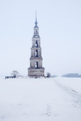 Fototapeta na wymiar Flooded bell tower of St. Nicholas in the middle of the Volga river at winter