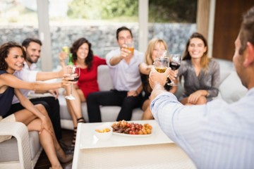 Group of friends toasting cocktail drinks